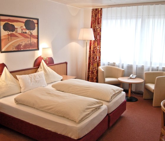 Dreibettzimmer als Beispiel mit Sitzgruppe, &copy; A. R&uuml;ber