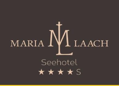 An elegant logo for the Seehotel Maria Laach. It features the hotel name in stylish lettering and four stars.