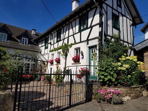 A charming half-timbered house with flowers in the windows. The garden is lovingly designed and invites you to linger.